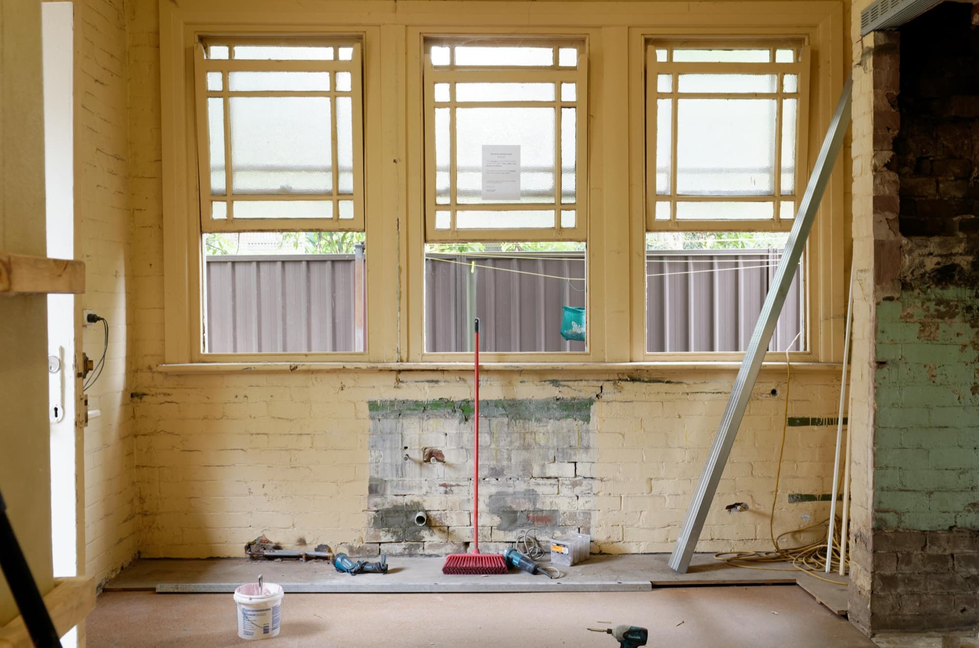 Stripped interior ready for remodeling: exposed brick, original windows